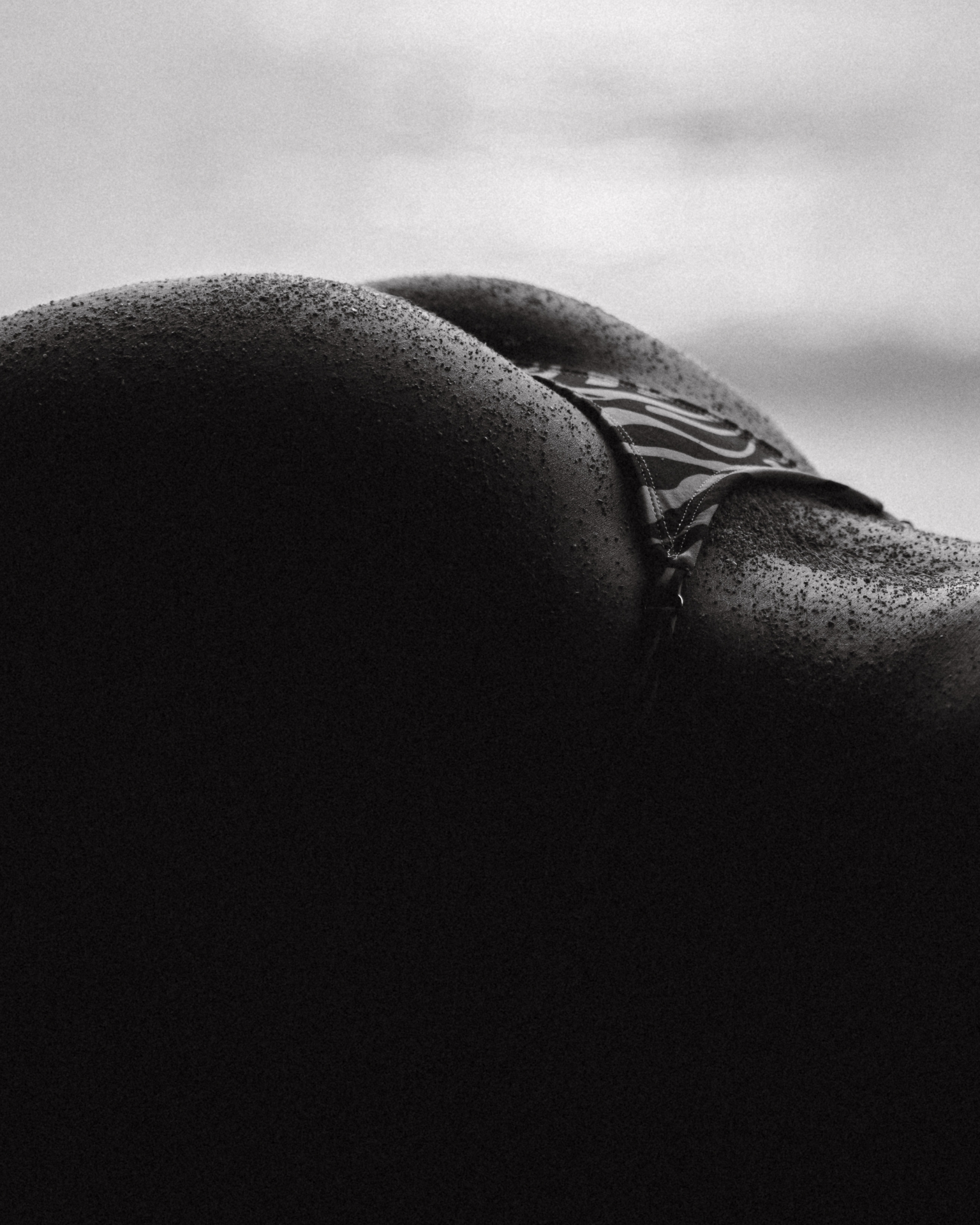 Black and white body detail with bikini strap