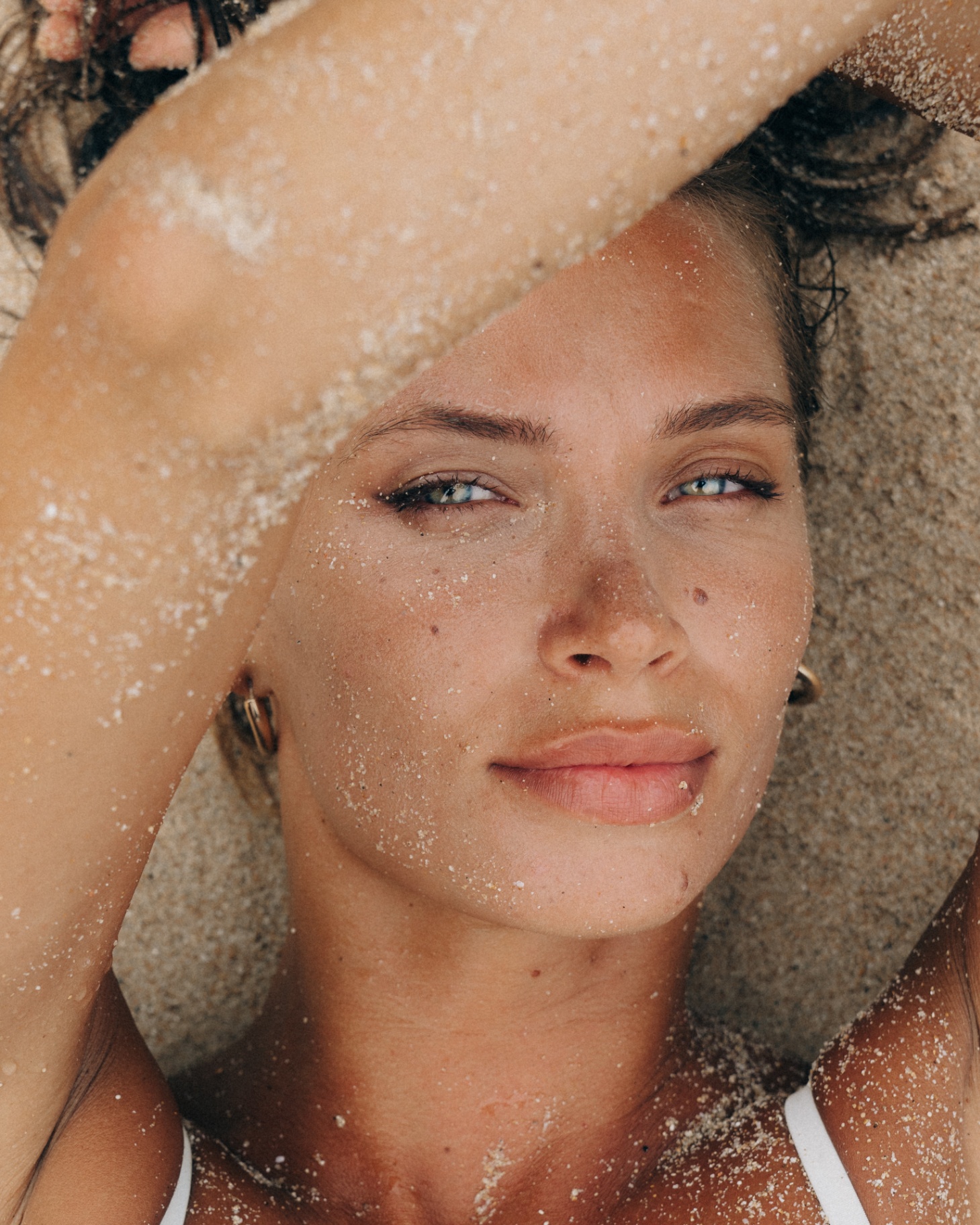 Sun-drenched close-up portrait with sand